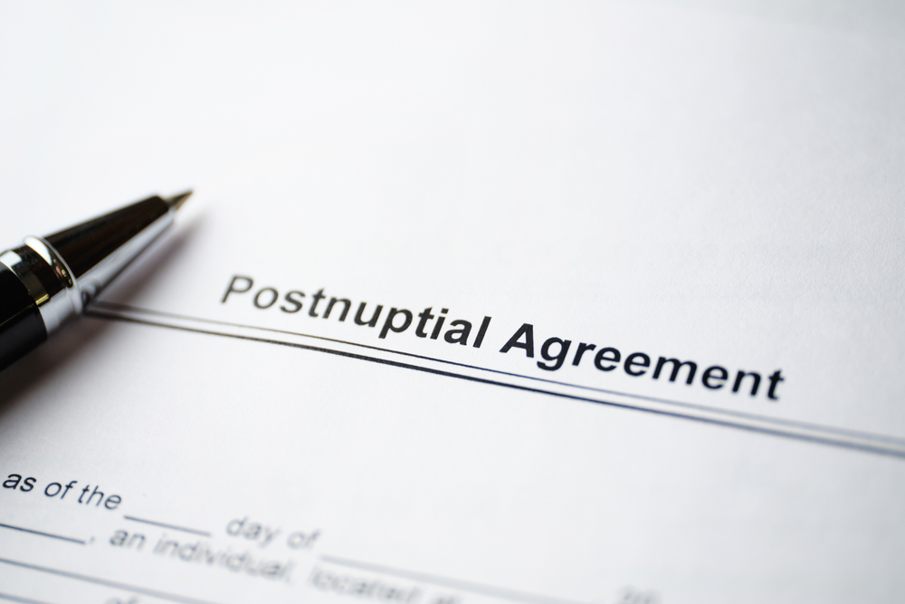 legal document postnuptial agreement on paper with pen